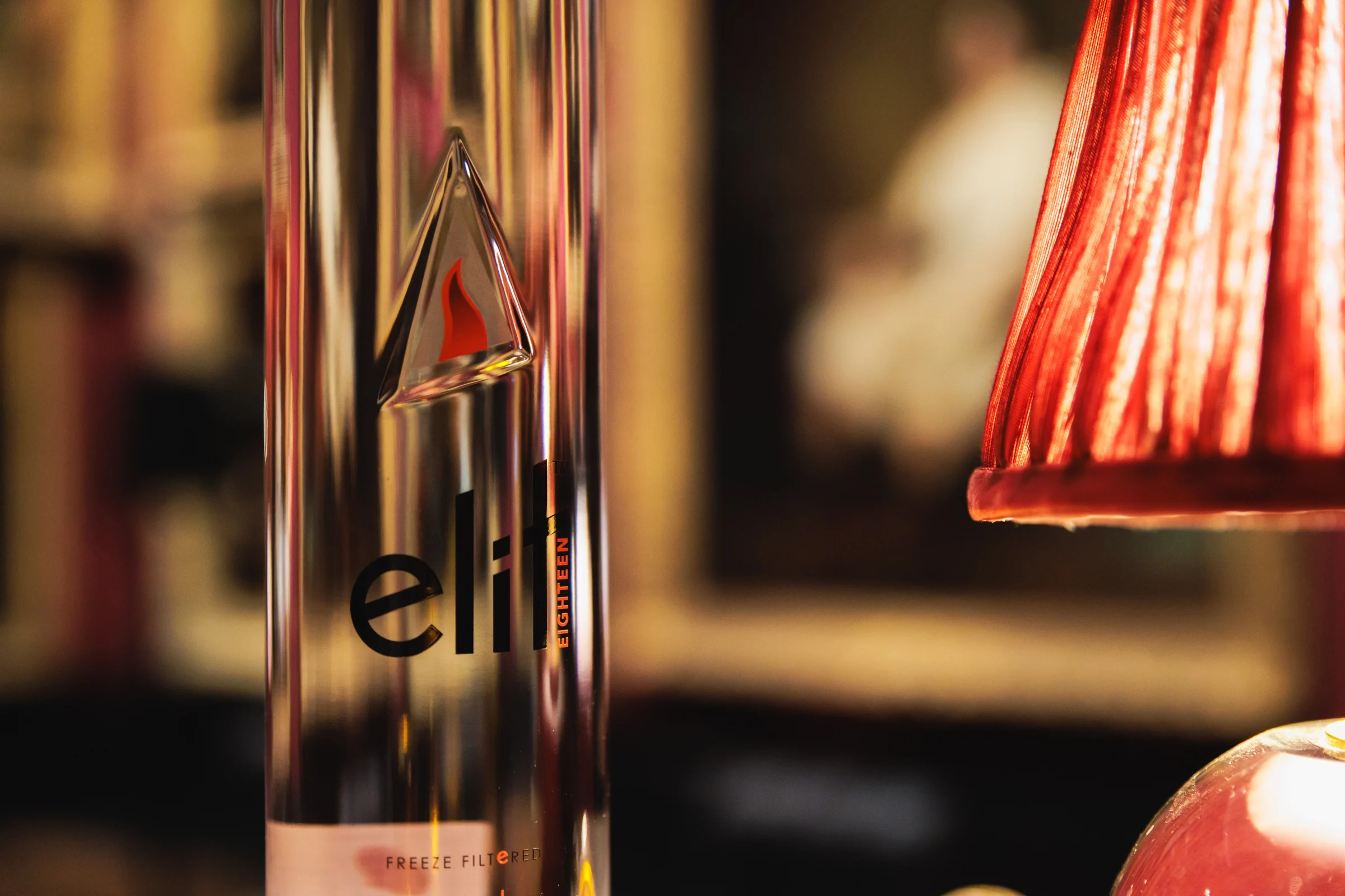 ELIT Vodka bottle beside a red lamp at the Private View
